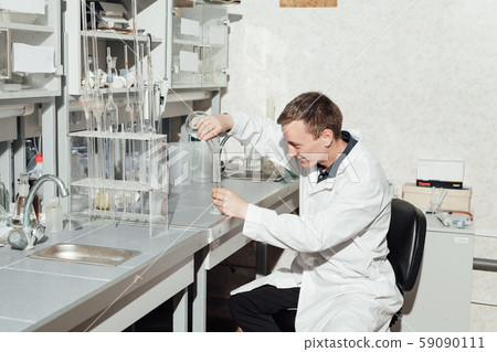 scientist in the medical laboratory conducts chemical experiments with liquids 59090111
