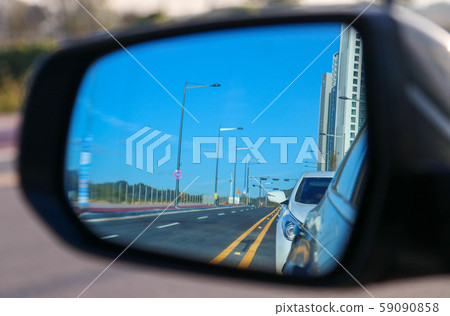 A road reflected in a rearview mirror A road reflected in a rearview mirror 59090858