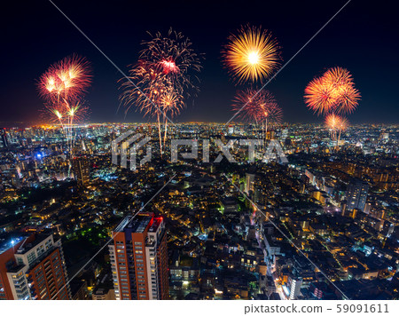 Fireworks over Tokyo cityscape at night, Japan 59091611