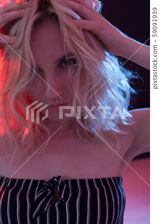 Portrait of a beautiful fashionable blonde woman in striped clothes Portrait of a beautiful fashionable blonde woman in striped clothes 59091939