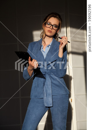 portrait of a beautiful woman in a business suit in the office at work portrait of a beautiful woman in a business suit in the office at work 59092596