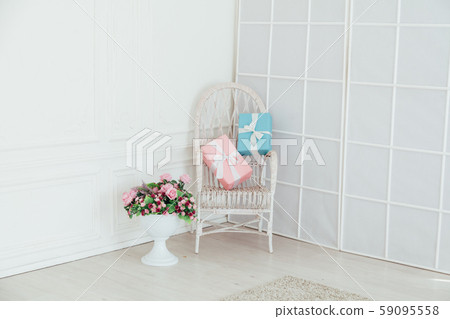 white vintage chair with gifts in the interior of a white empty room 59095558