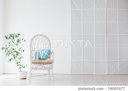 white vintage chair with gifts in the interior of a white empty room 59095977