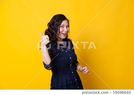 Portrait of a beautiful Asian woman shows a thumbs up Portrait of a beautiful Asian woman shows a thumbs up 59096688