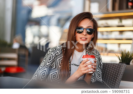 Beautiful young girl with coffee Beautiful young girl with coffee 59098731