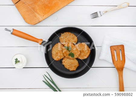 Delicious pancakes from potatoes in a frying pan. 59098802