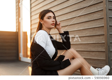 Fashion young beautiful woman in a black coat Fashion young beautiful woman in a black coat 59098960