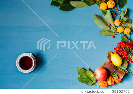 Red and yellow autumn leaves fruit nuts on a grey background Red and yellow autumn leaves fruit nuts on a grey background 59102702
