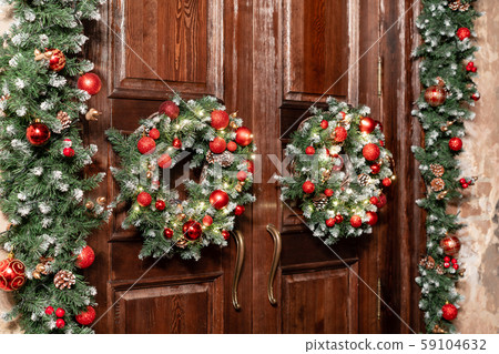 House entrance decorated for holidays. Christmas decoration. Two wreaths and garland of fir tree 59104632