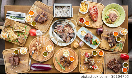 Barbecue restaurant menu. Many different food on the table. Dinner party or Banquet. Top view 59104705