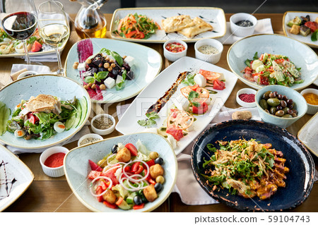 Variety of dishes on the table. Various snacks and antipasti on the table. Restaurant menu. Italian Variety of dishes on the table. Various snacks and antipasti on the table. Restaurant menu. Italian 59104743