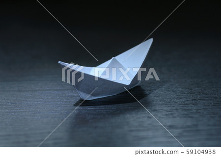 paper boat on a dark table 59104938