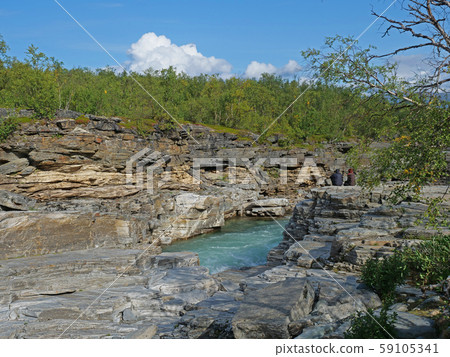 Two tourist couple sitting at blue glacial river Two tourist couple sitting at blue glacial river 59105341