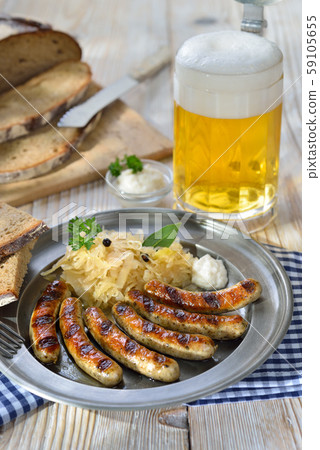 Fried sausages from Nuremberg with sauerkraut 59105655