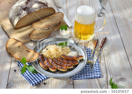 Fried sausages from Nuremberg with sauerkraut Fried sausages from Nuremberg with sauerkraut 59105657