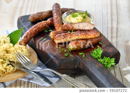 Bavarian sausages from Nuremberg served with sauerkraut Bavarian sausages from Nuremberg served with sauerkraut 59107272