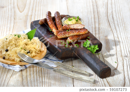 Bavarian sausages from Nuremberg served with sauerkraut Bavarian sausages from Nuremberg served with sauerkraut 59107273