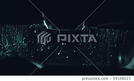 Drops flow down the windscreen. Inside view of a windshield car. Dark black cinematic picture 59108021
