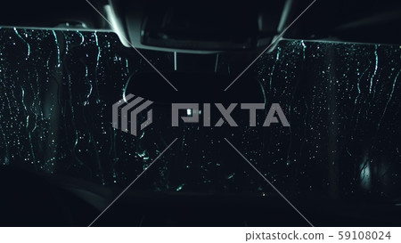 Drops flow down the windscreen. Inside view of a windshield car. Dark black cinematic picture 59108024