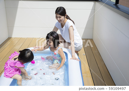 Kids playing in a vinyl pool Kids playing in a vinyl pool 59109497