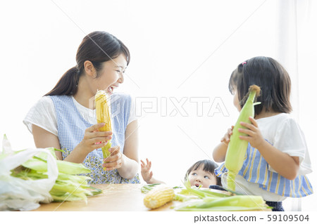 Mom and girl peeling corn Mom and girl peeling corn 59109504
