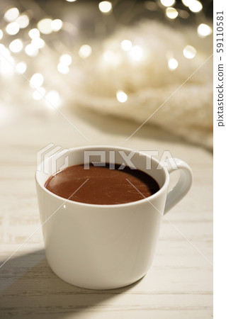 White ceramic cup of hot cocoa on white wooden 59110581