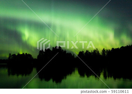 Northern lights over lake in Finland 59110611