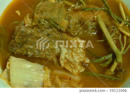fried fish and egg stuffed climbing wattle in spicy sour soup on bowl 59111006