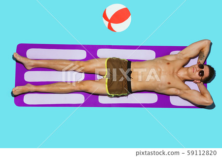 Top view of young caucasian male model's resting on beach resort Top view of young caucasian male model's resting on beach resort 59112820