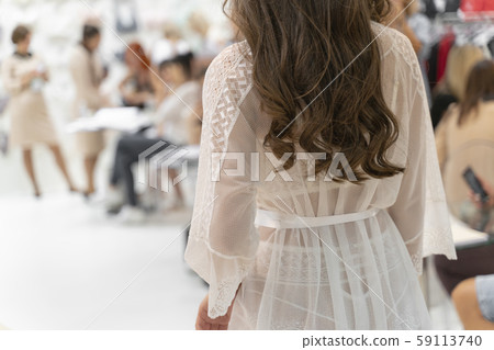 Young girl demonstrates delicate, white and soft negligee Young girl demonstrates delicate, white and soft negligee 59113740