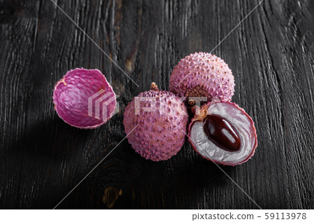 three lychees on a dark wooden background three lychees on a dark wooden background 59113978