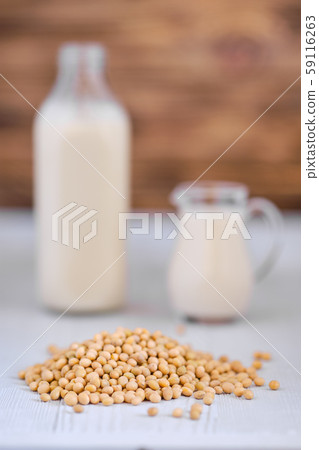 Bottle and pitcher of soy milk on white table Bottle and pitcher of soy milk on white table 59116263