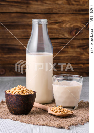 Bottle of soy milk with soybeans on white table Bottle of soy milk with soybeans on white table 59116265