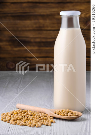 Bottle of soy milk with soybeans on white table Bottle of soy milk with soybeans on white table 59116266
