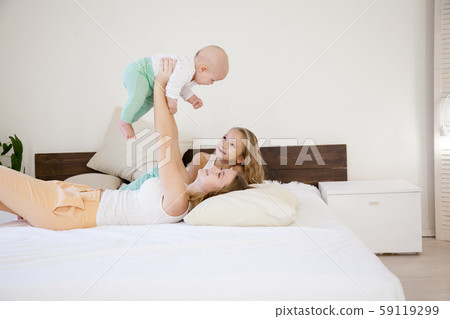 three little girls sisters in the bedroom on the bed 59119299