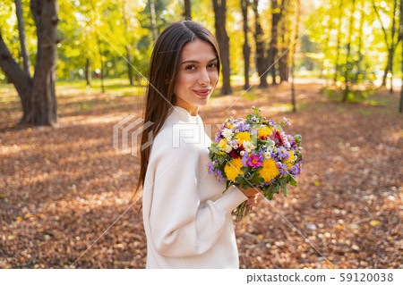 Happy pretty woman is walking alone outdoors Happy pretty woman is walking alone outdoors 59120038