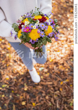 Pretty flowers in hands of a woman Pretty flowers in hands of a woman 59120041