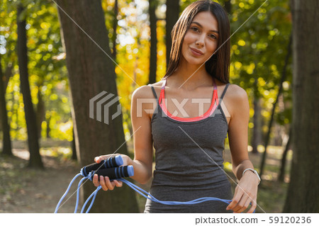 Cheerful lady packing up at the end of training 59120236