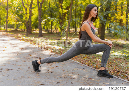 Beautiful woman exercising in the morning park 59120787