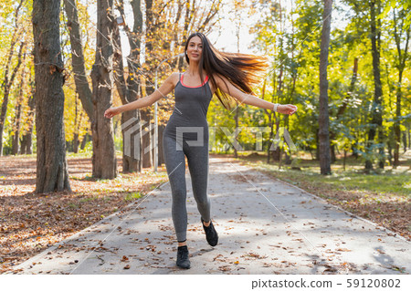 Beautiful woman beginning her morning exercises outside Beautiful woman beginning her morning exercises outside 59120802