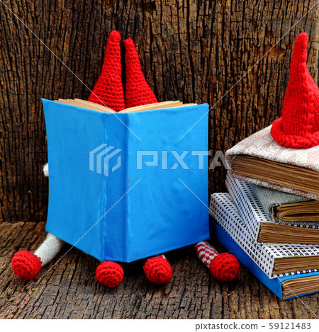 Busy concept with face hidden by book, looking for information 59121483