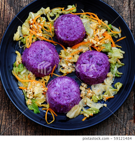 black plate of violet rice dish with vegetables, delicious vegan meal 59121484