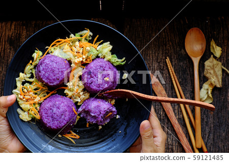 black plate of violet rice dish with vegetables, delicious vegan meal black plate of violet rice dish with vegetables, delicious vegan meal 59121485