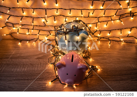 Pink and blue piggy bank with glittering lights, organize parties for successful activities to save money for retirement Pink and blue piggy bank with glittering lights, organize parties for successful activities to save money for retirement 59122108