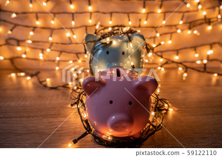 Pink and blue piggy bank with glittering lights, organize parties for successful activities to save money for retirement Pink and blue piggy bank with glittering lights, organize parties for successful activities to save money for retirement 59122110