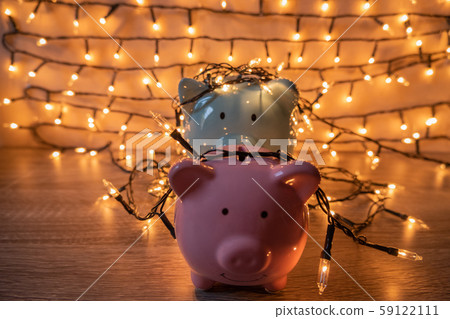 Pink and blue piggy bank with glittering lights, organize parties for successful activities to save money for retirement Pink and blue piggy bank with glittering lights, organize parties for successful activities to save money for retirement 59122111