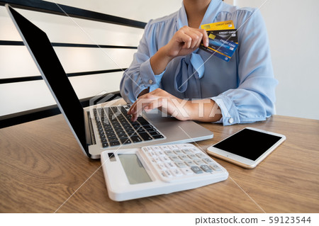 Business woman consumer holding credit card and smartphone for online shopping and payment make a purchase on the Internet Business woman consumer holding credit card and smartphone for online shopping and payment make a purchase on the Internet 59123544