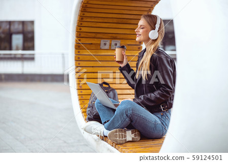 Pleased student girl taking a rest outside 59124501