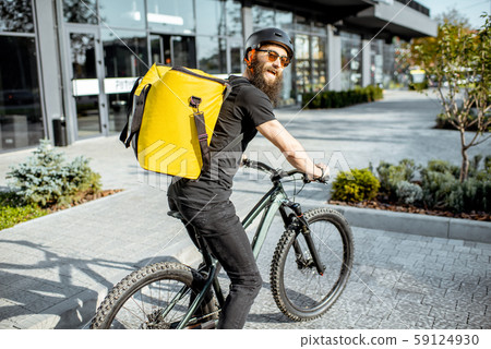 Courier delivering food on a bicycle Courier delivering food on a bicycle 59124930