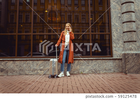 Female tourist with a smartphone looking away 59125478